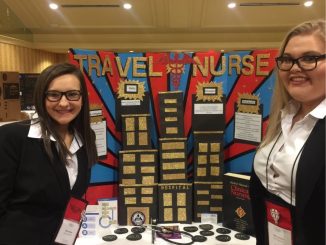 Knox HOSA members pose in front of their display showing information about travel nurses.