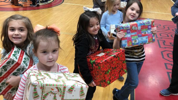 Students at Girdler shown accepting gifts