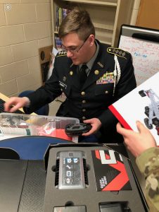 JROTC cadets reviewing new tools they received to the program.