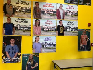 Banners display photos of students who scored Distinguished on KPREP at Central.