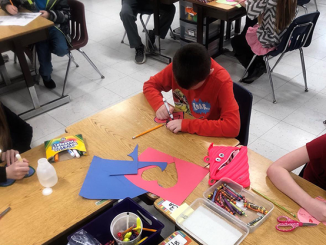 Students carefully cut out Valentine's Day hearts to send to children at St. Jude's.