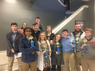 Lynn Camp DECA students shown with trophies and medals after the regional competition.