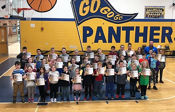Students hold awards received during Central Elementary's Panther Way assembly on Friday, February 8.