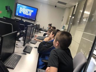 Students are shown in the learning lab at KET with computers and green screen technology.