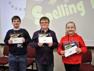 Top three winners in the Knox County Spelling Bee pose for a photo with awards and gifts from sponsors.