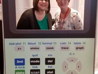 Fatemia Fuson and Rachel Wyatt pose for a photo in a calculator cut-out while at the T3 conference.