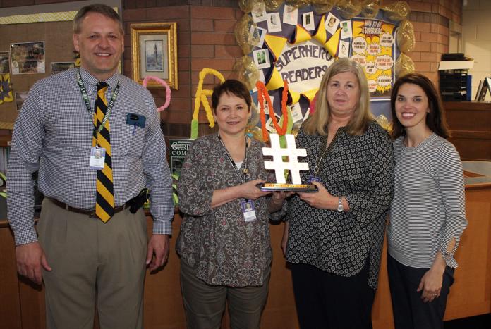 Jeff Frost (principal) and Wendy King (KEDC) are shown with Teresa Gambrel and Sherry Faulkner, recipients of the traveling #readknoxky hashtag.