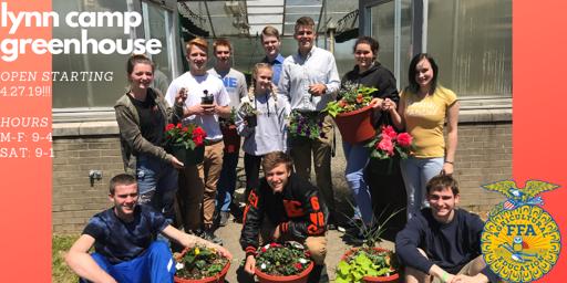 Lynn Camp students pose with flowers and plants at the greenhouse grand opening.