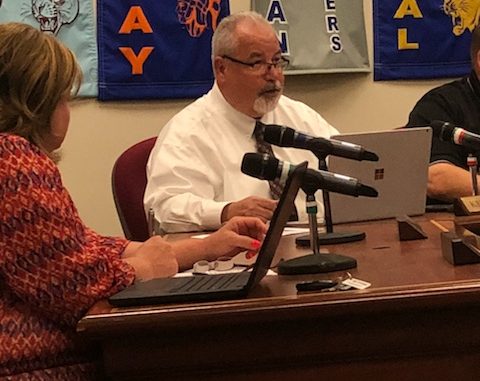 Kelly Sprinkles is shown at the Board table during the June 2019 meeting. Carrie Smith is shown to left.