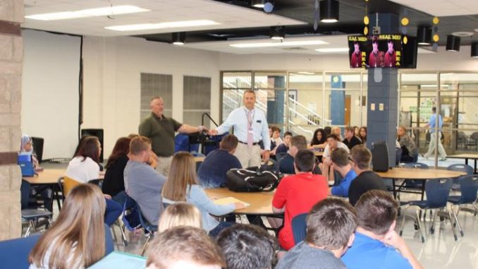 Assembly shown in the Knox Central cafeteria with Jeff Canady and Jeff Frost at the microphone addressing students.