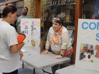 A student is shown at the Community Service exhibit during RUSH week at Knox Central.