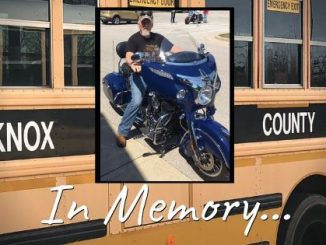 Bus in background, photo of Tommy Marlow in front with text "In Memory..."