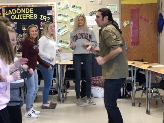 Yani Vozos is shown teaching Spanish students different dance moves.