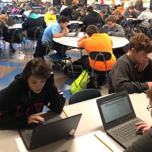 Two students are shown close up working on the timed CERT assessment using a computer.
