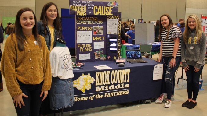 KCMS students are shown at their exhibit during the regional STLP promoting their community service project.
