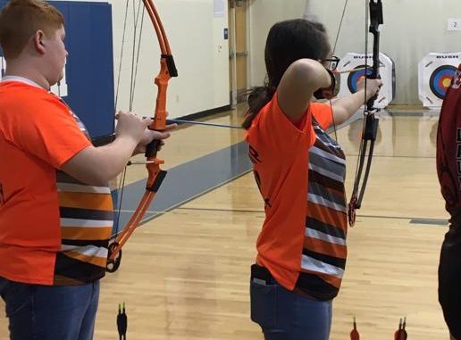 Two Lynn Camp archers are shown ready to shoot.