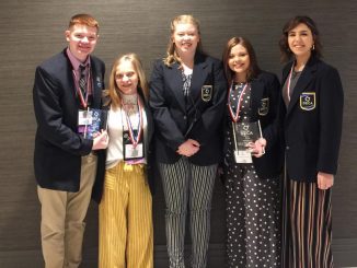 Five Lynn Camp students shown with medals after winning at DECA state competition.