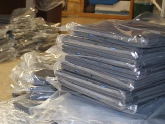 Unboxed Chromebooks are shown waiting to be prepared for student deployment