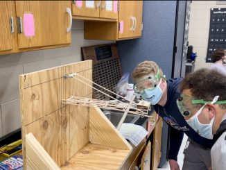 Students are shown constructing one of their many projects for Science Olympiad.