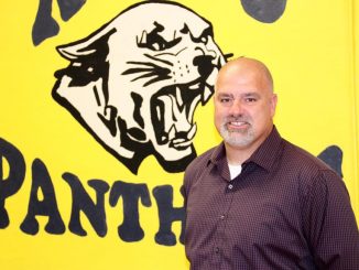 Photo of Fred Hoskins in front of a KCMS Panther backdrop