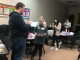 Two teachers are shown in the foreground participating in a Kagan structure.