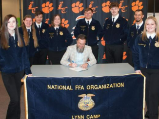 Superintendent Ledford is shown with FFA officers during a proclamation signing at their school.