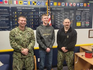 Brayden Hinkle is shown with recruiters from the U.S. Navy after signing his letter of commitment.