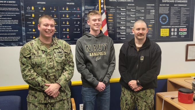 Brayden Hinkle is shown with recruiters from the U.S. Navy after signing his letter of commitment.