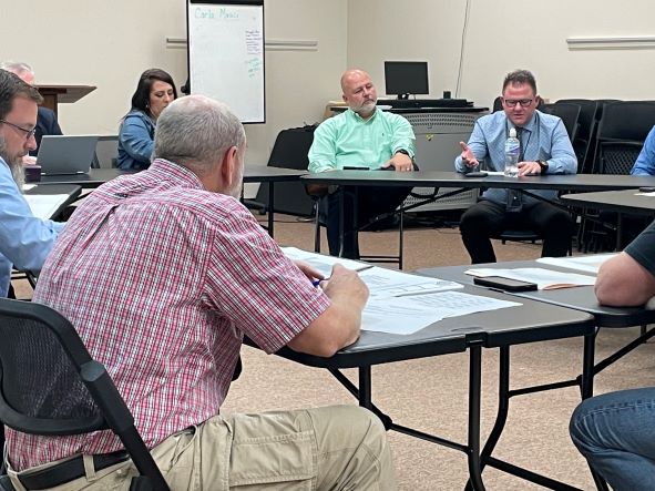 Principals Ralph Halcomb and Anthony Pennington are shown sitting in front of Board members discussing their vision for the CTC.