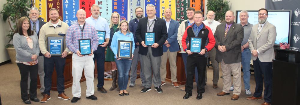 Principals and board members are shown with plaques for placing in the top 25% in the state on accountability.