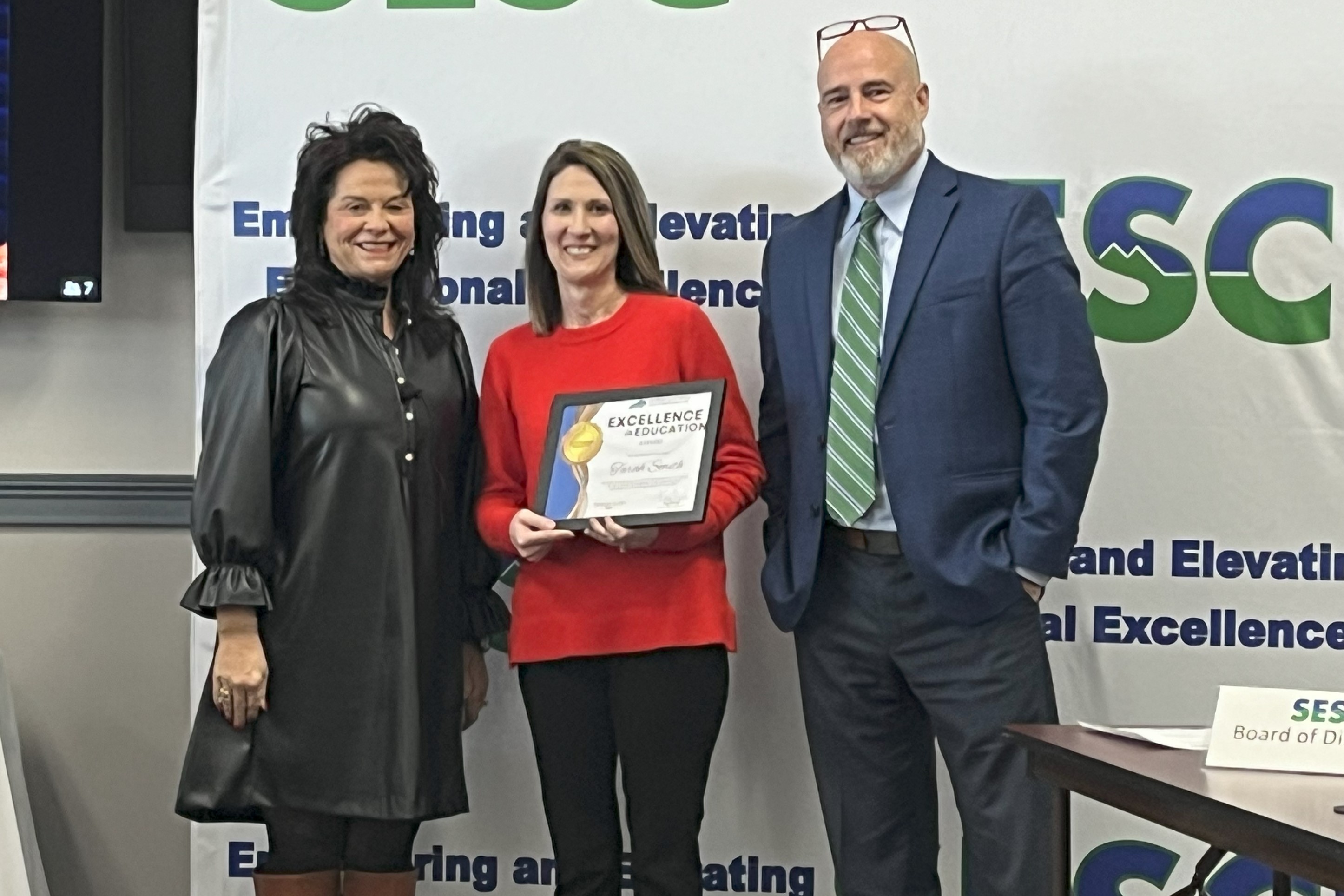 Smith is shown being recognized by SESC education cooperative